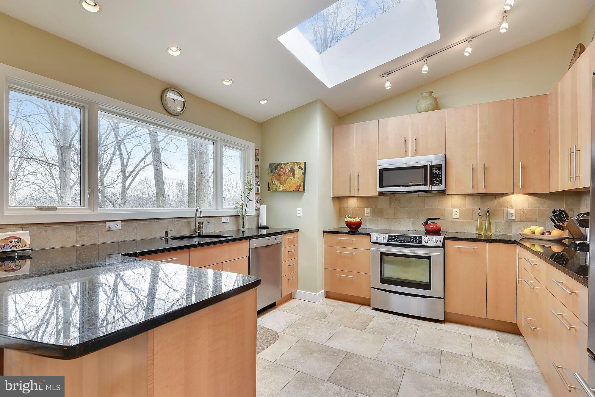 7600 Hamilton Spring Road Bethesda, MD 20817 - Photo 8 of 24 a large kitchen with stainless steel appliances granite countertop a stove and a sink