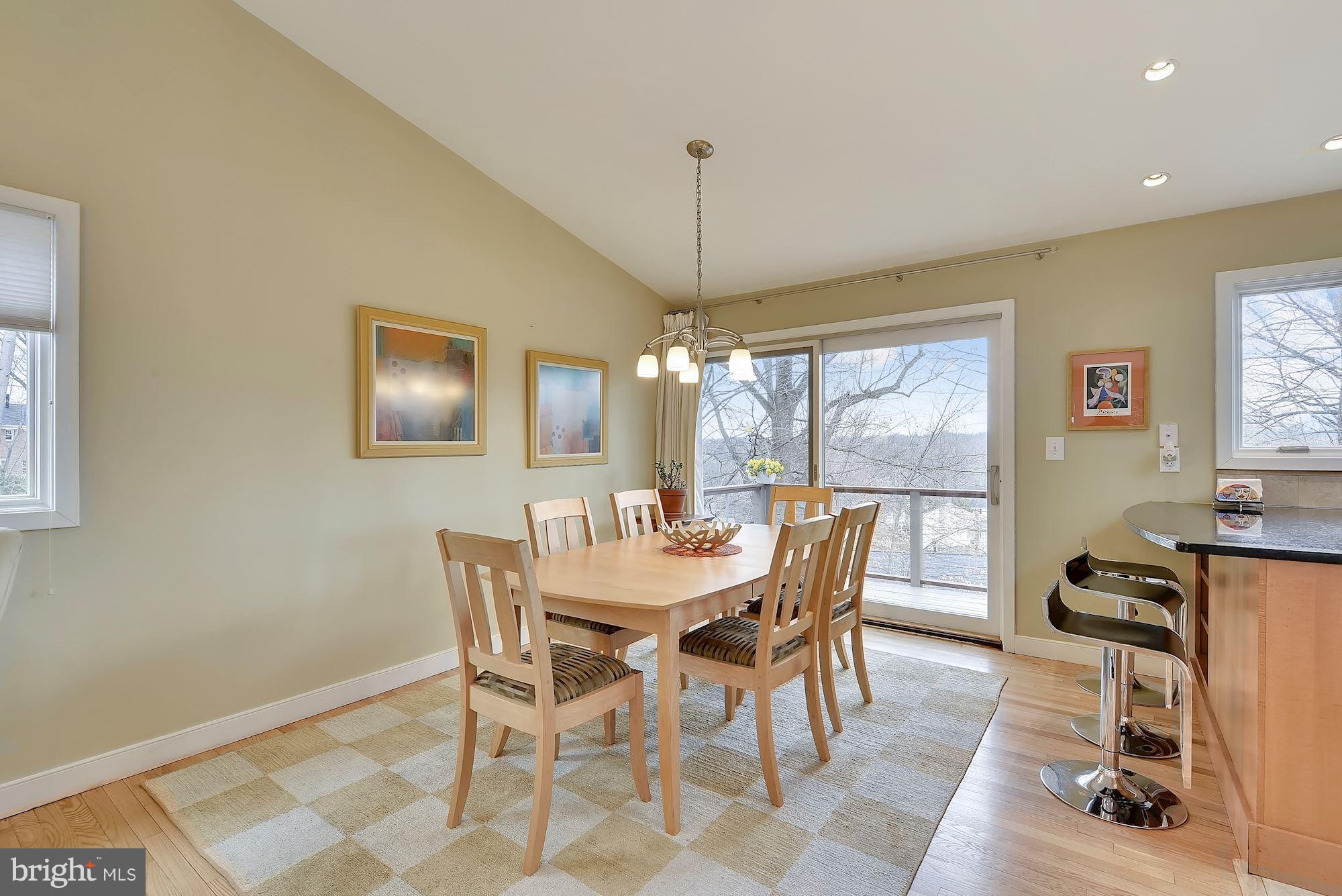 7600 Hamilton Spring Road Bethesda, MD 20817 - Photo 9 of 24 a dining room with furniture a chandelier and wooden floor