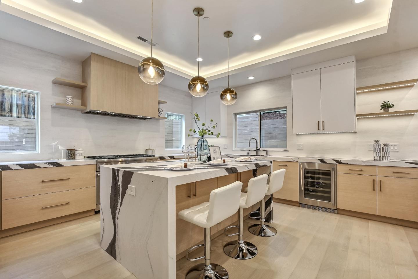 10047 Crescent Road Cupertino, CA 95014 - Photo 14 of 43 a kitchen with a stove a chandelier and white cabinets