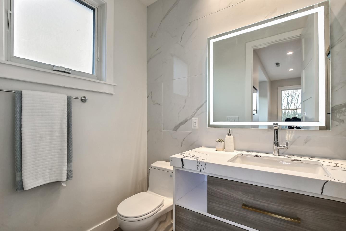 10047 Crescent Road Cupertino, CA 95014 - Photo 21 of 43 a bathroom with a sink vanity mirror and toilet
