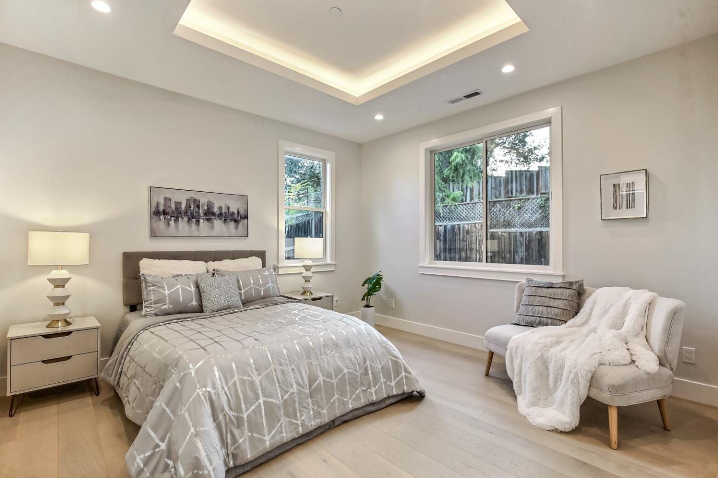 10047 Crescent Road Cupertino, CA 95014 - Photo 24 of 43 a bedroom with a bed and wooden floor