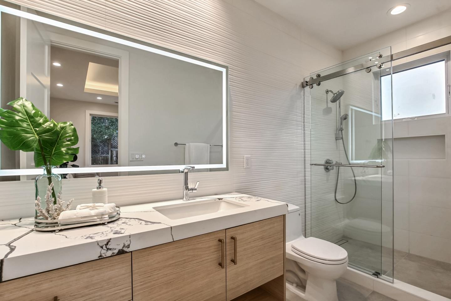 10047 Crescent Road Cupertino, CA 95014 - Photo 25 of 43 a bathroom with a granite countertop sink toilet and shower