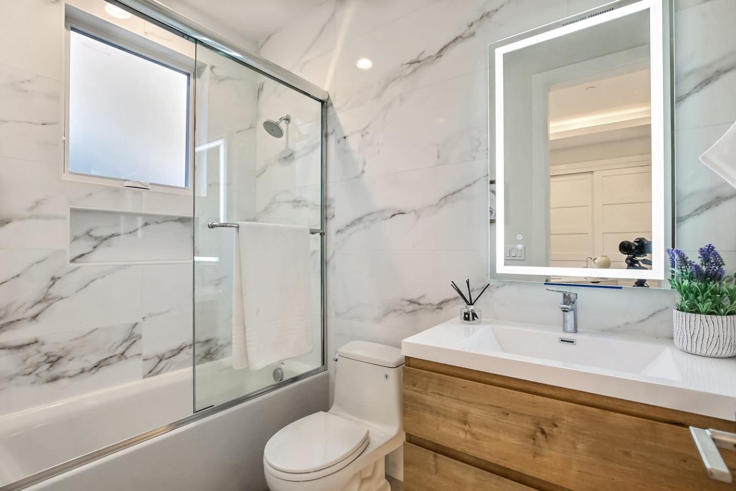 10047 Crescent Road Cupertino, CA 95014 - Photo 27 of 43 a bathroom with a sink a toilet and shower