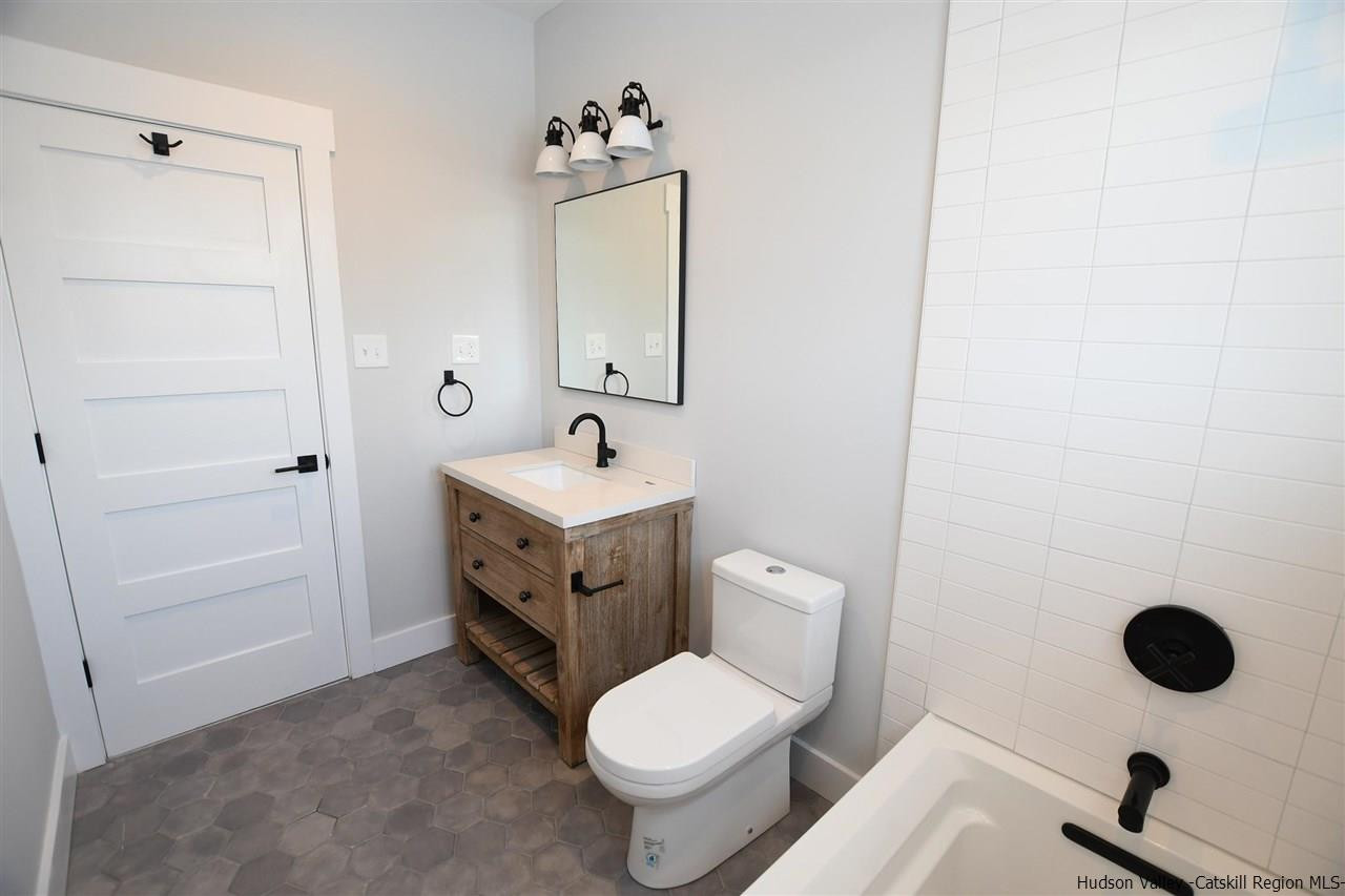 460 County Road Callicoon, NY 12723 - Photo 23 of 33 a bathroom with a toilet sink and mirror
