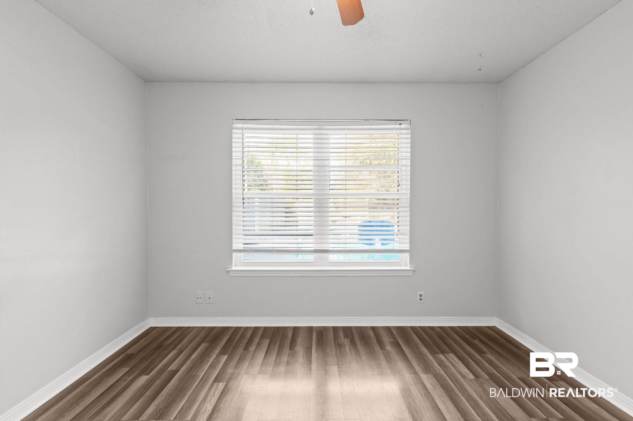 3864 Leroy Stevens Road Mobile, AL 36619 - Photo 23 of 33 Spare room with ceiling fan, dark wood-style floors, and a textured ceiling
