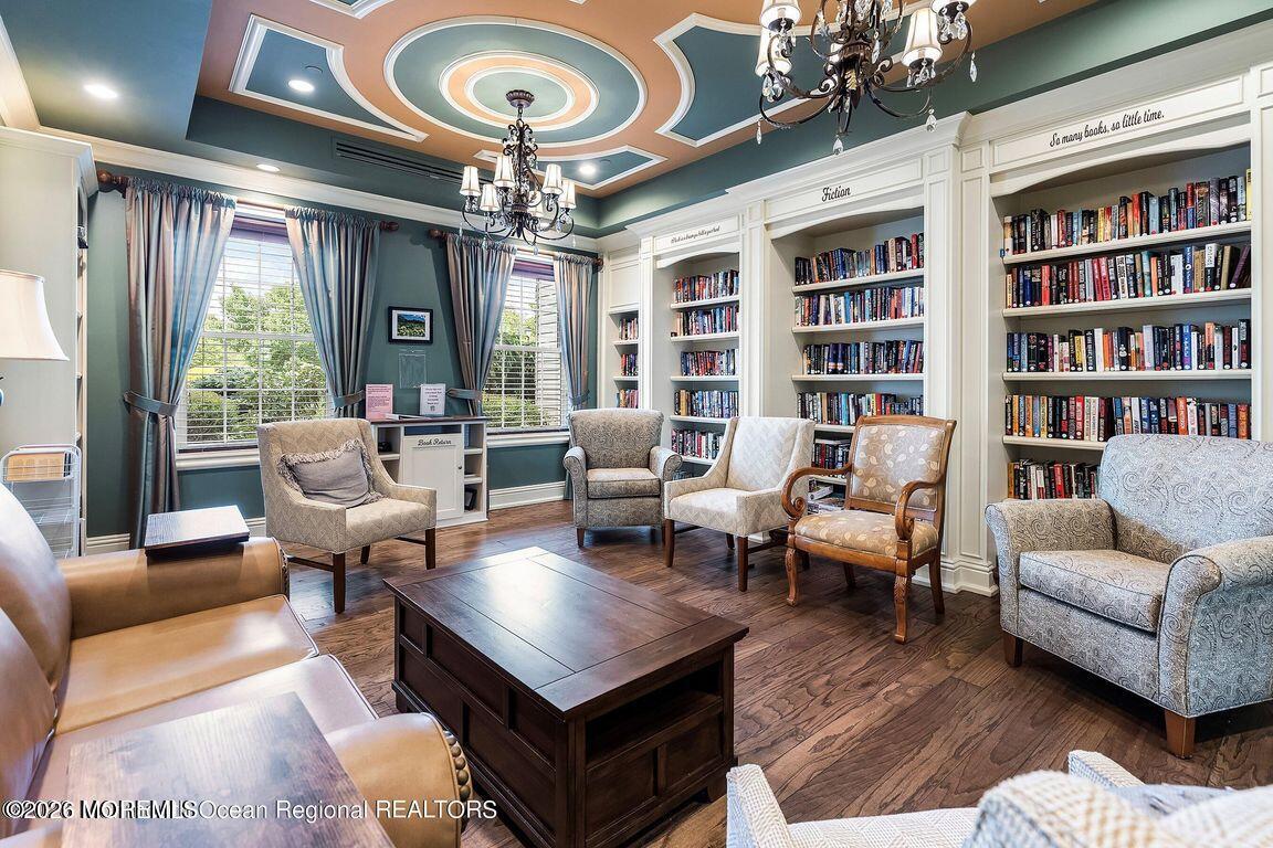 46 Pancoast Road Waretown, NJ 08758 - Photo 49 of 55 a living room with furniture a chandelier and a bookshelf