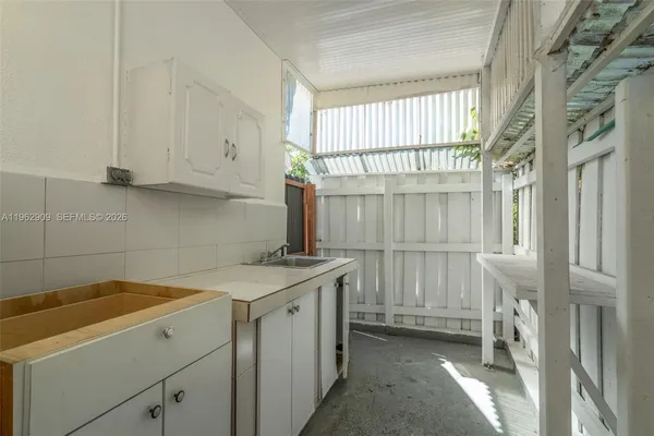 a view of a kitchen with a sink and cabinets