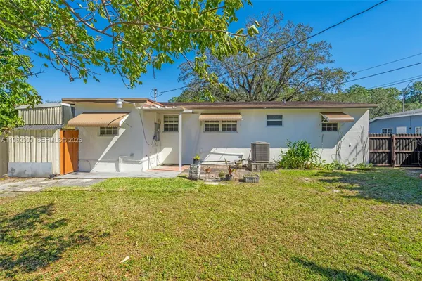 a view of a house with a yard and sitting area