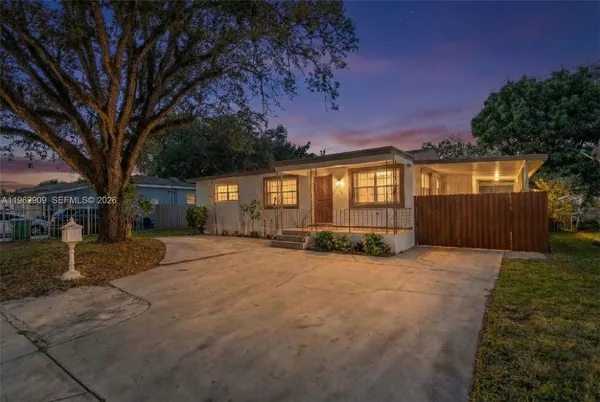 front view of a house with a yard and garage
