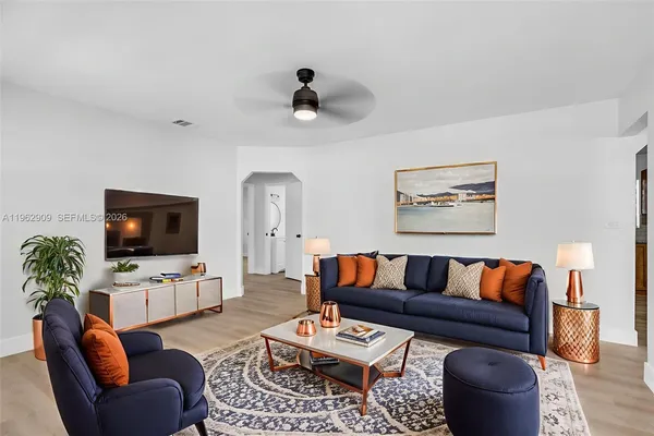 a living room with furniture and a flat screen tv