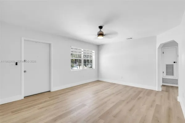 wooden floor in an empty room with a window