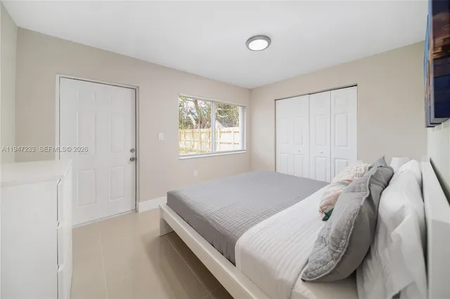 a bedroom with a bed and a window