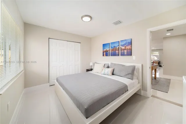 a bedroom with a bed and a window