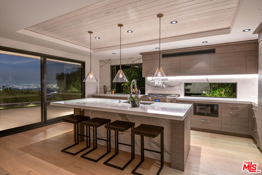 2715 Edwin Place Los Angeles, CA 90046 - Photo 15 of 52 a kitchen with a sink a counter and chairs