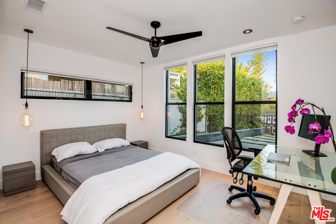 2715 Edwin Place Los Angeles, CA 90046 - Photo 34 of 52 a bedroom with a bed a computer on the desk and a large window