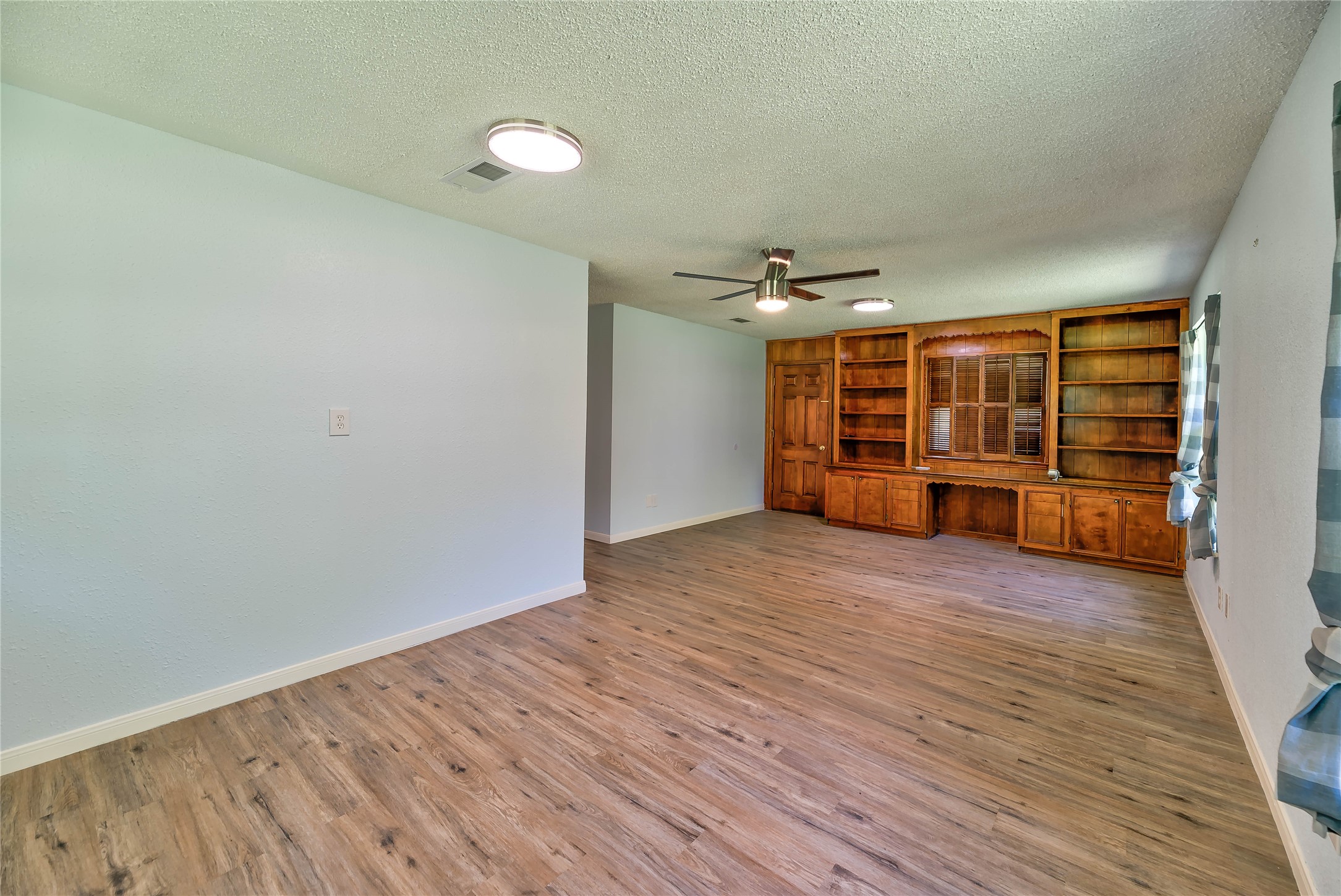 3003 Paul Knox Street Huntsville, TX 77320 - Photo 13 of 46 a view of empty room with wooden floor
