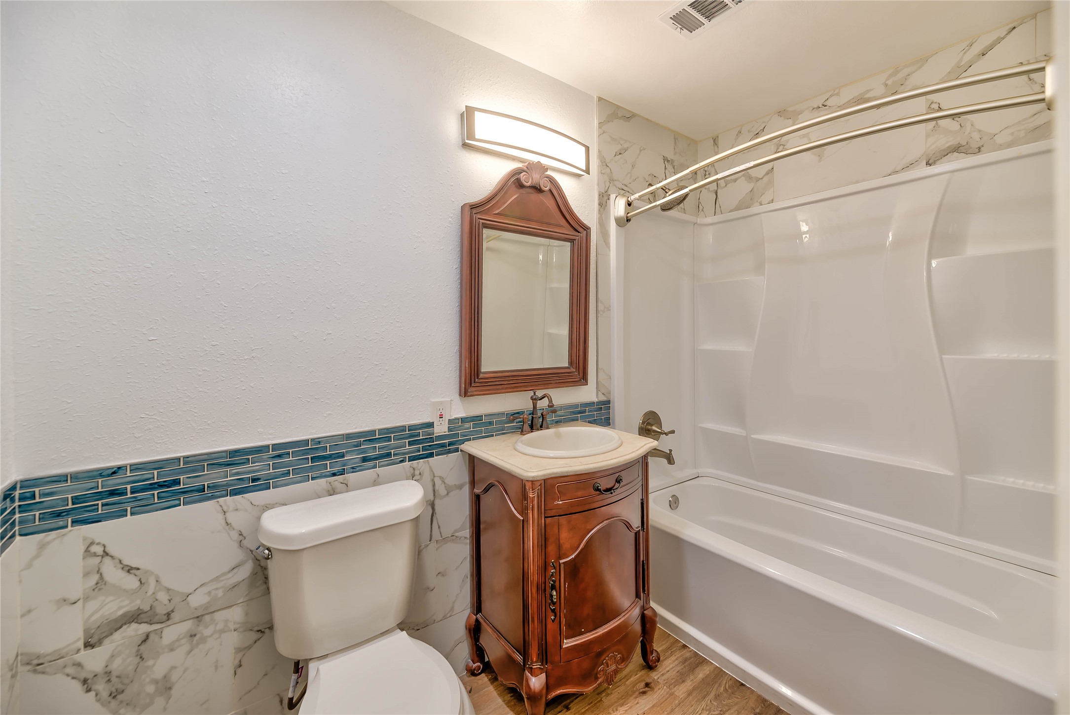 3003 Paul Knox Street Huntsville, TX 77320 - Photo 20 of 46 a bathroom with a granite countertop toilet sink and mirror