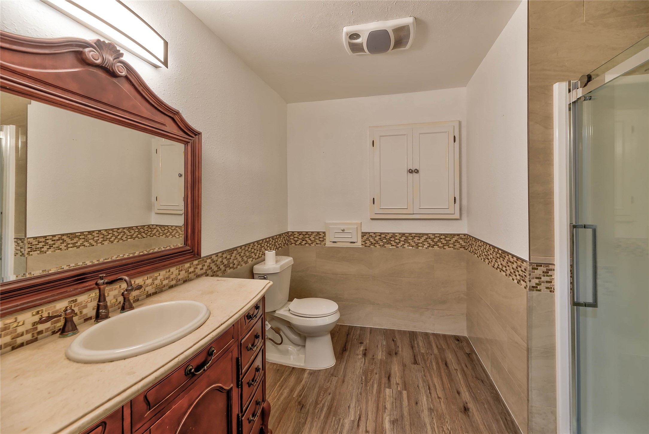 3003 Paul Knox Street Huntsville, TX 77320 - Photo 22 of 46 a bathroom with a sink a toilet and a mirror