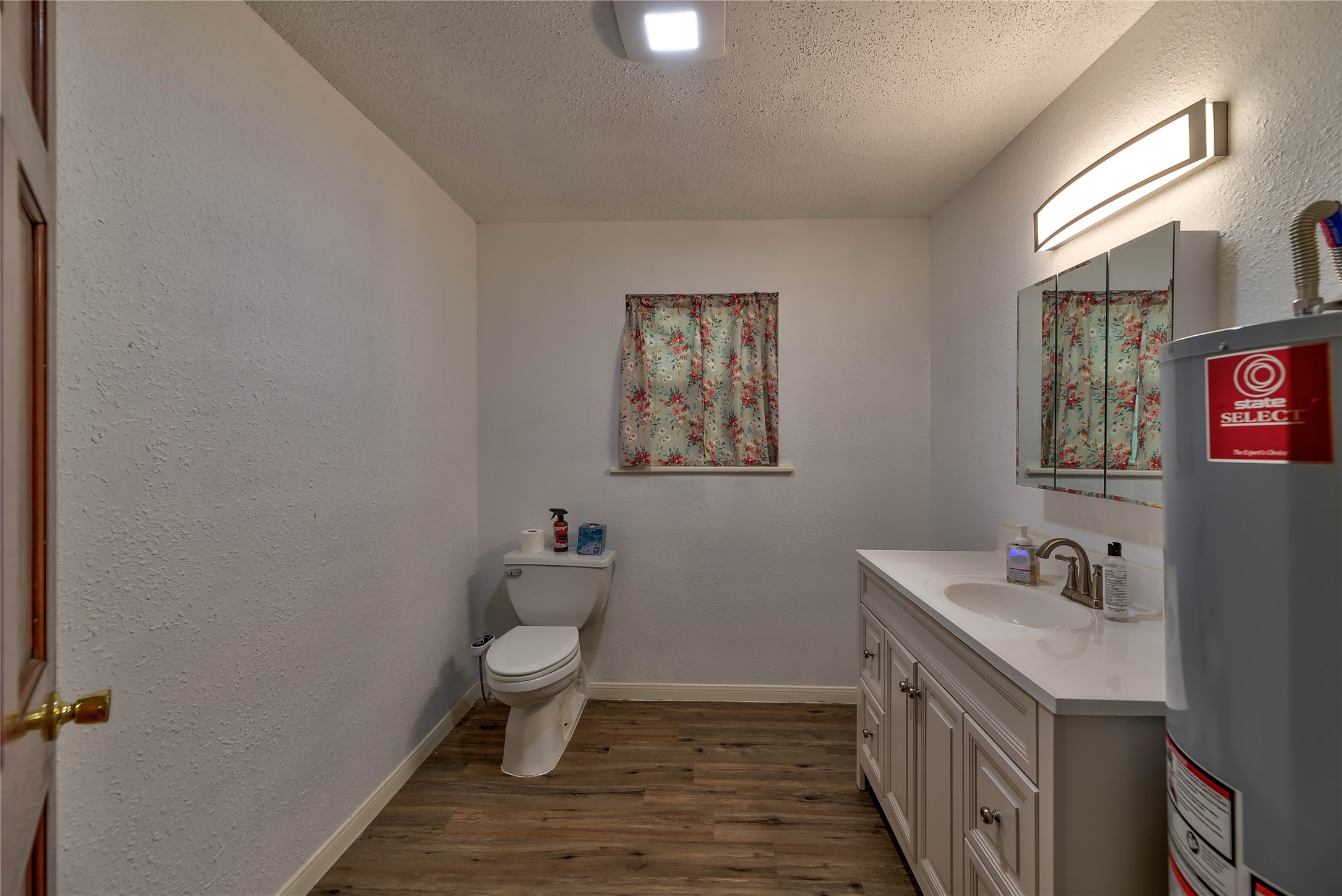 3003 Paul Knox Street Huntsville, TX 77320 - Photo 26 of 46 a bathroom with a toilet sink and mirror