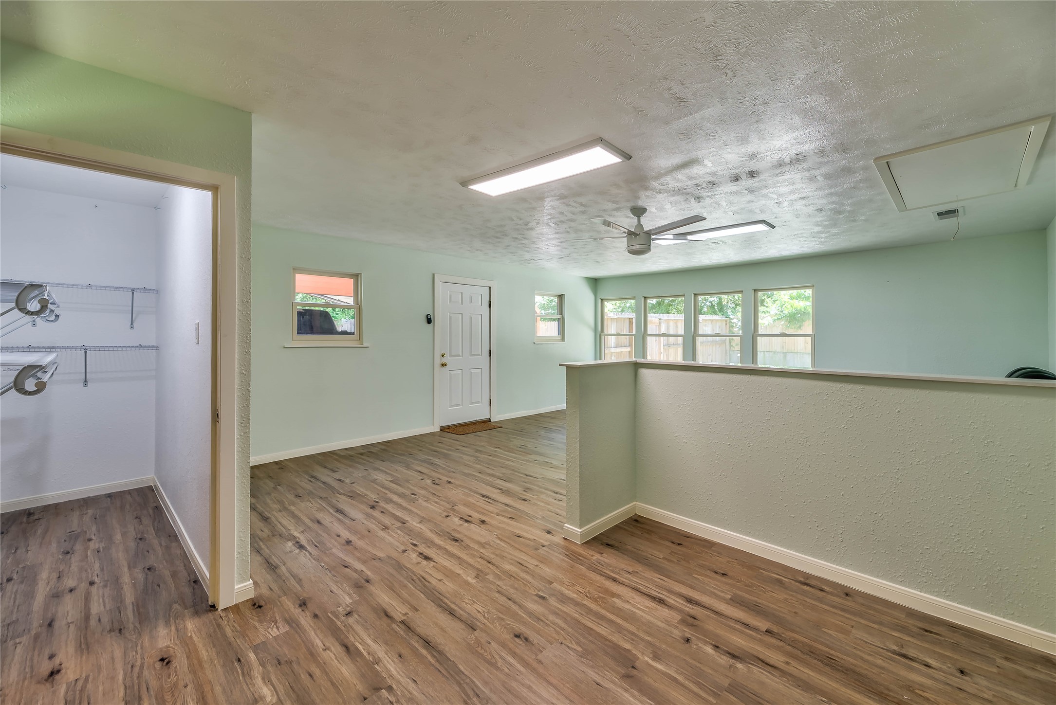 3003 Paul Knox Street Huntsville, TX 77320 - Photo 27 of 46 an empty room with wooden floor and windows