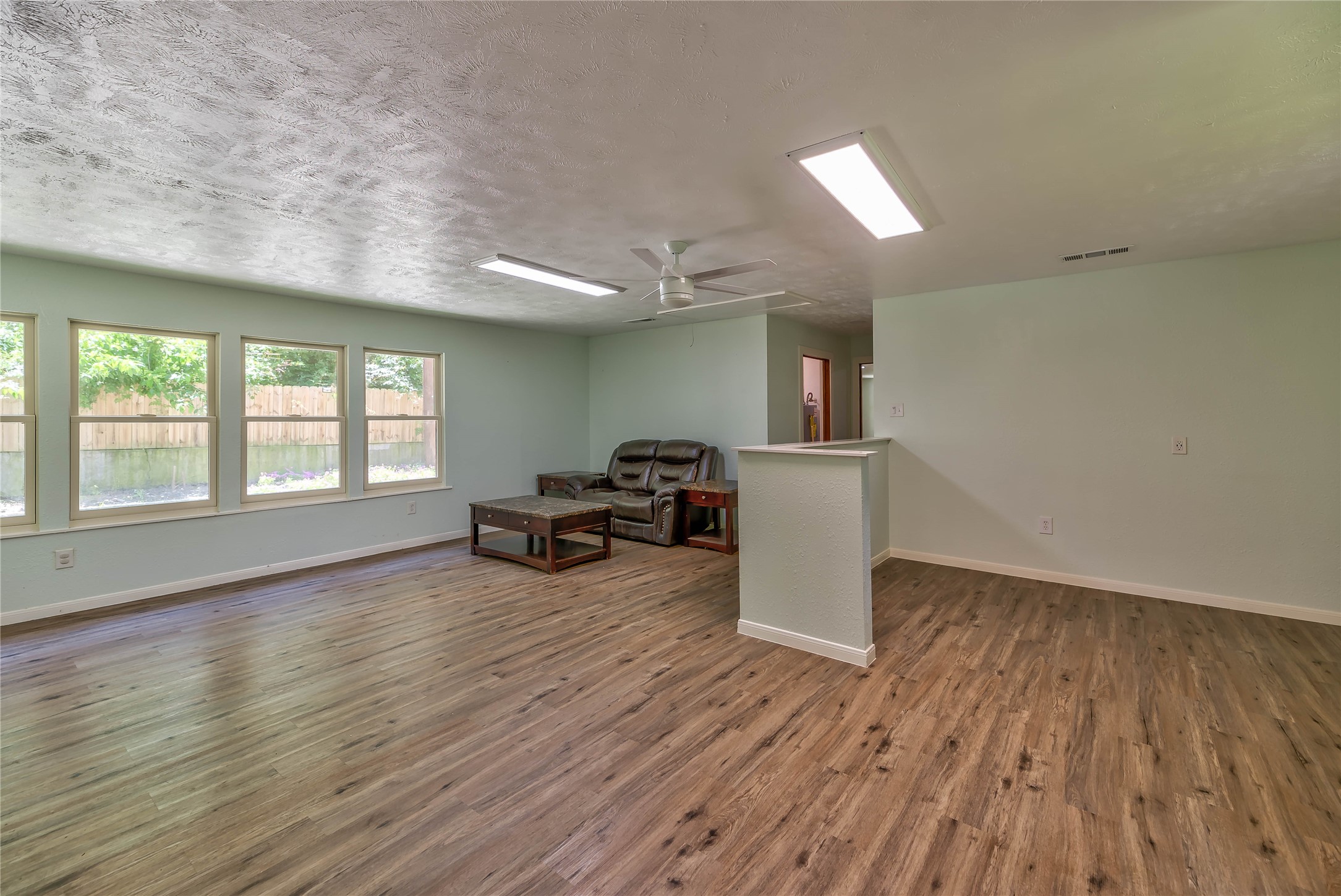 3003 Paul Knox Street Huntsville, TX 77320 - Photo 28 of 46 an empty room with wooden floor and furniture