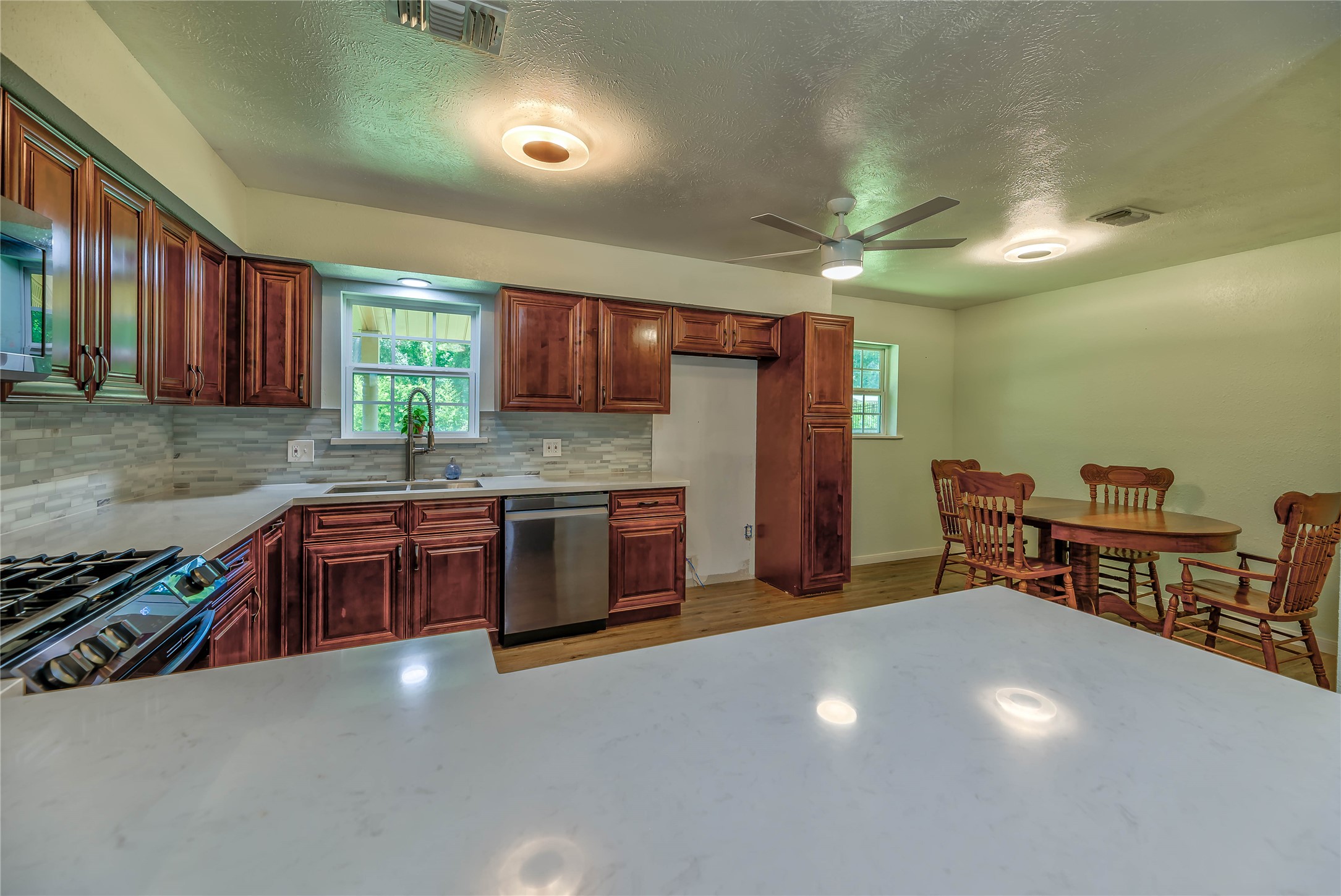3003 Paul Knox Street Huntsville, TX 77320 - Photo 3 of 46 a kitchen with stainless steel appliances a stove a sink cabinets and a refrigerator