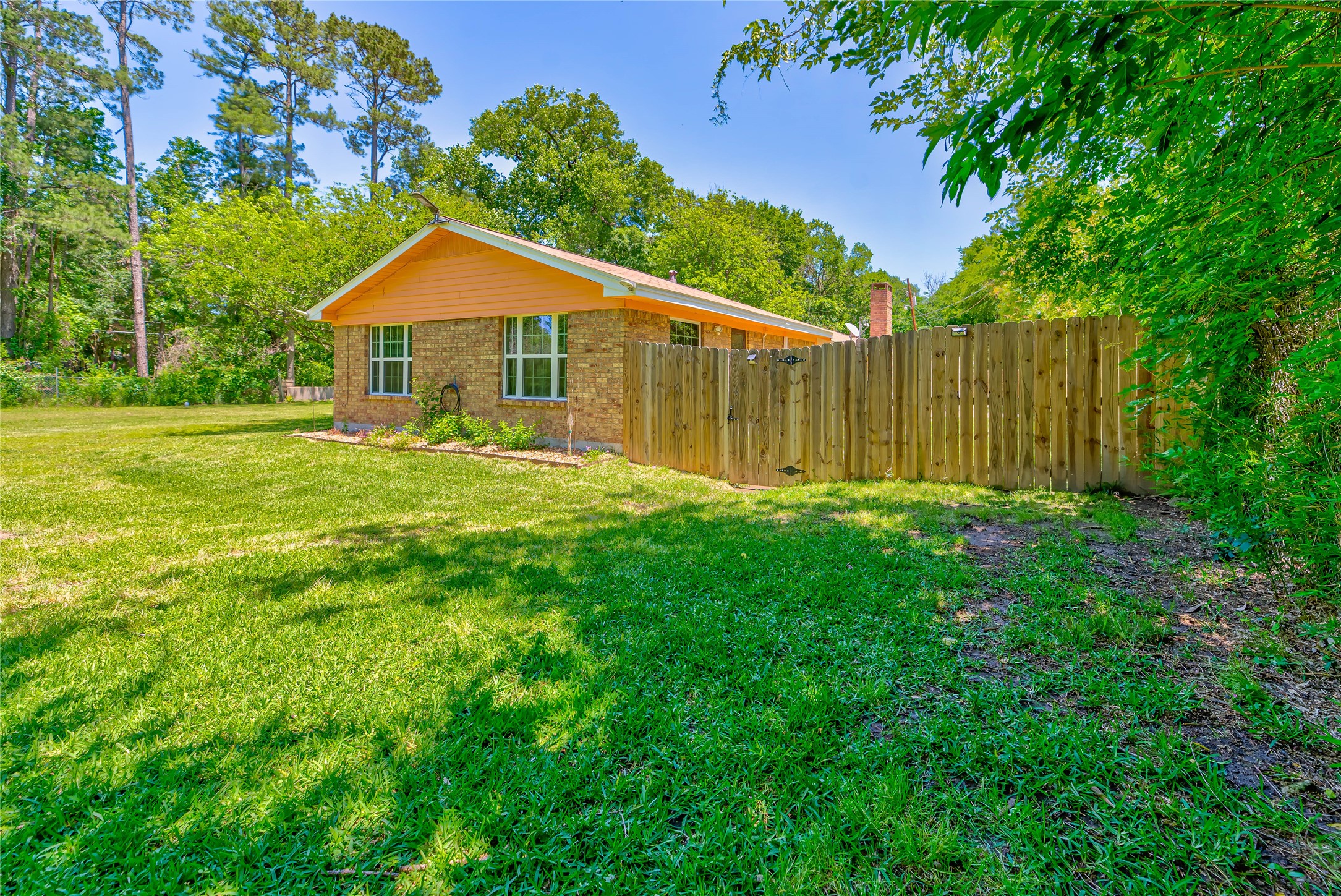 3003 Paul Knox Street Huntsville, TX 77320 - Photo 33 of 46 a backyard of a house with table and chairs