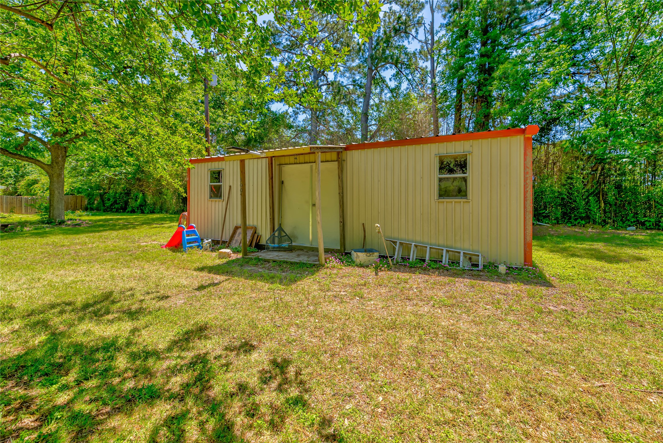 3003 Paul Knox Street Huntsville, TX 77320 - Photo 35 of 46 a view of backyard with slide and a large tree
