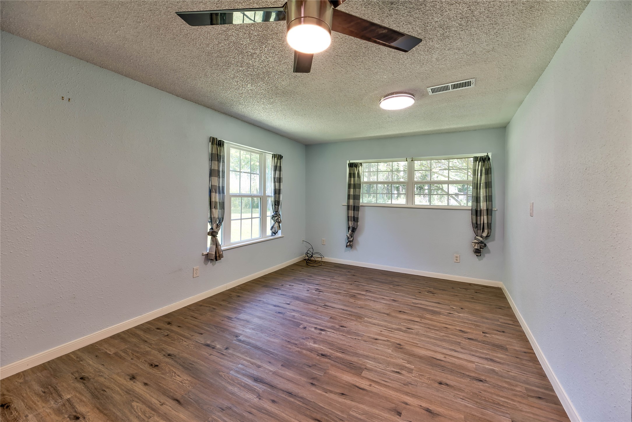 3003 Paul Knox Street Huntsville, TX 77320 - Photo 10 of 46 a view of an empty room with wooden floor and a window