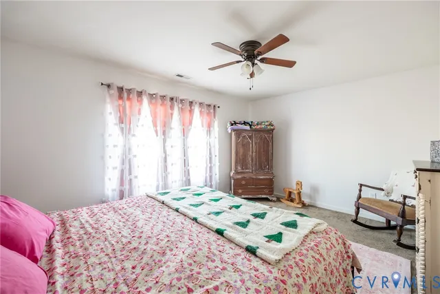 a bedroom with a bed and a dresser in it