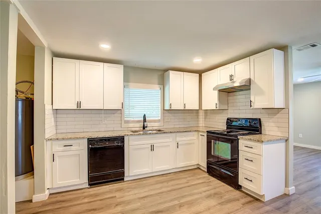 a kitchen with stainless steel appliances granite countertop a stove and a sink