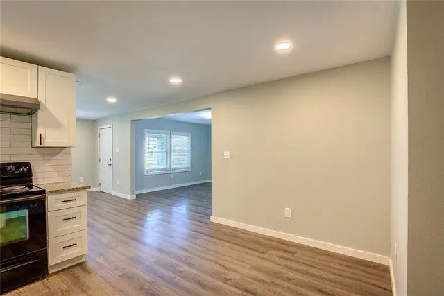 a view of a kitchen with a sink and a stove top oven
