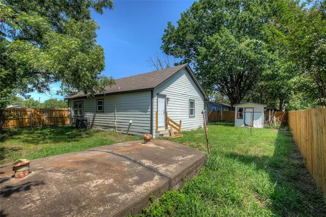 a view of backyard of house with green space