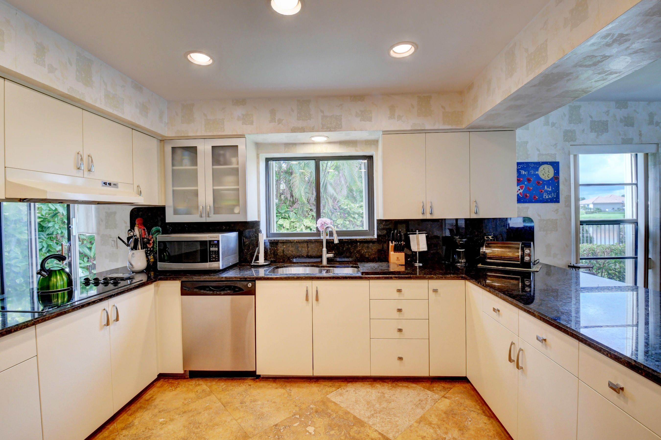 17331 Springtree Lane Boca Raton, FL 33487 - Photo 18 of 60 a kitchen with granite countertop a stove top oven sink and cabinets
