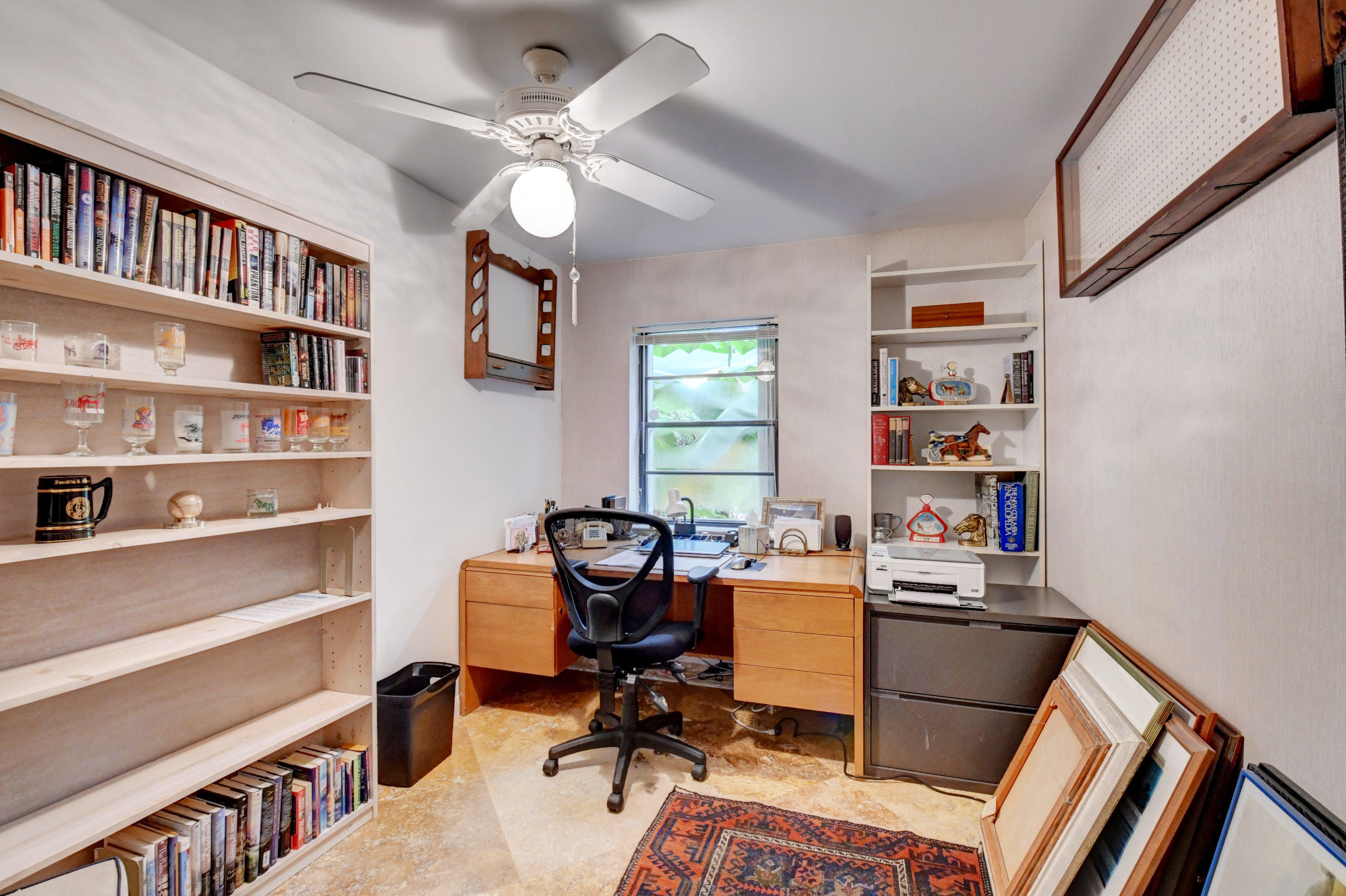 17331 Springtree Lane Boca Raton, FL 33487 - Photo 28 of 60 a view of a workspace with furniture and a bookshelf