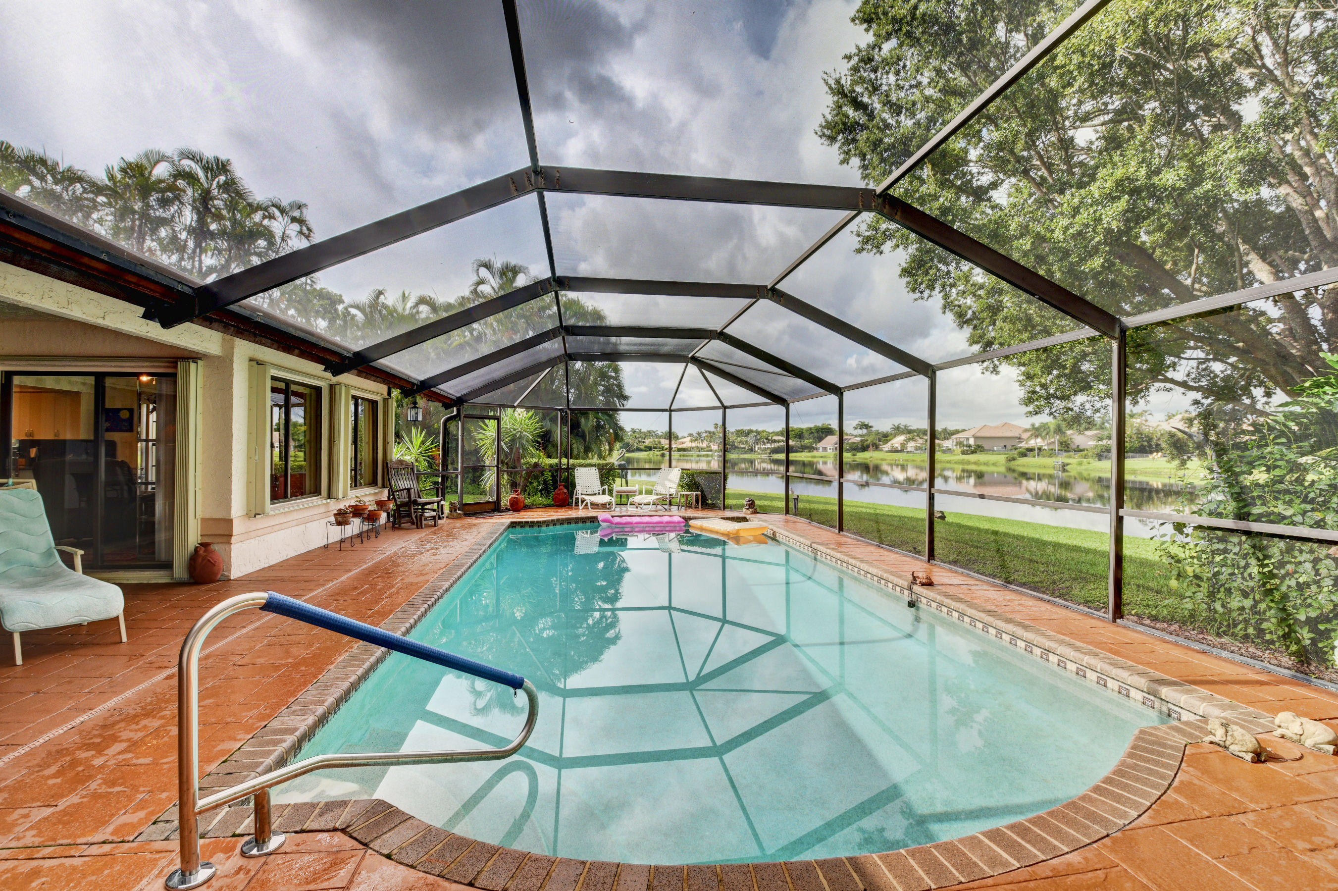 17331 Springtree Lane Boca Raton, FL 33487 - Photo 33 of 60 a view of a swimming pool with a patio