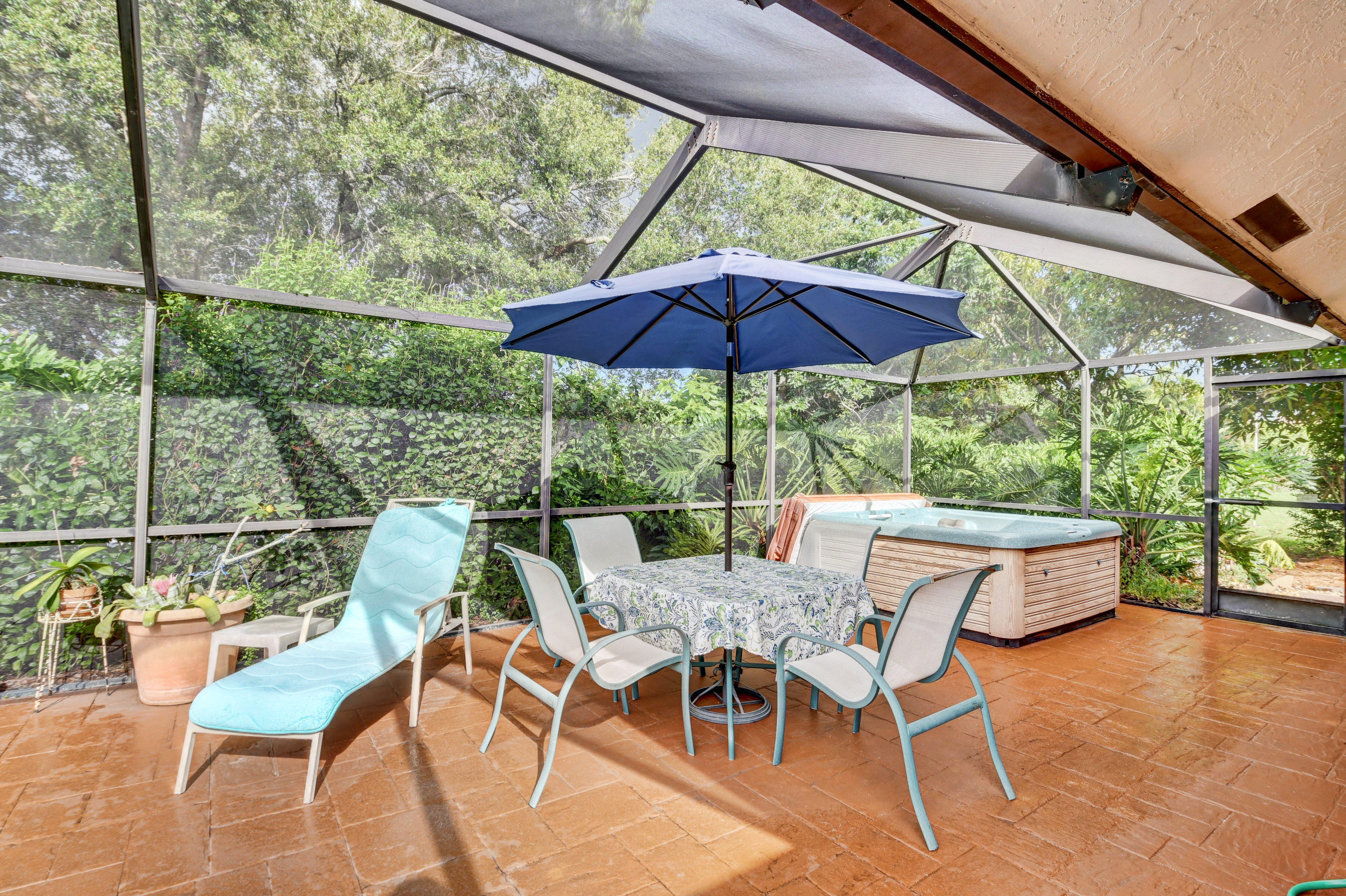17331 Springtree Lane Boca Raton, FL 33487 - Photo 34 of 60 a view of patio with table and chairs under an umbrella
