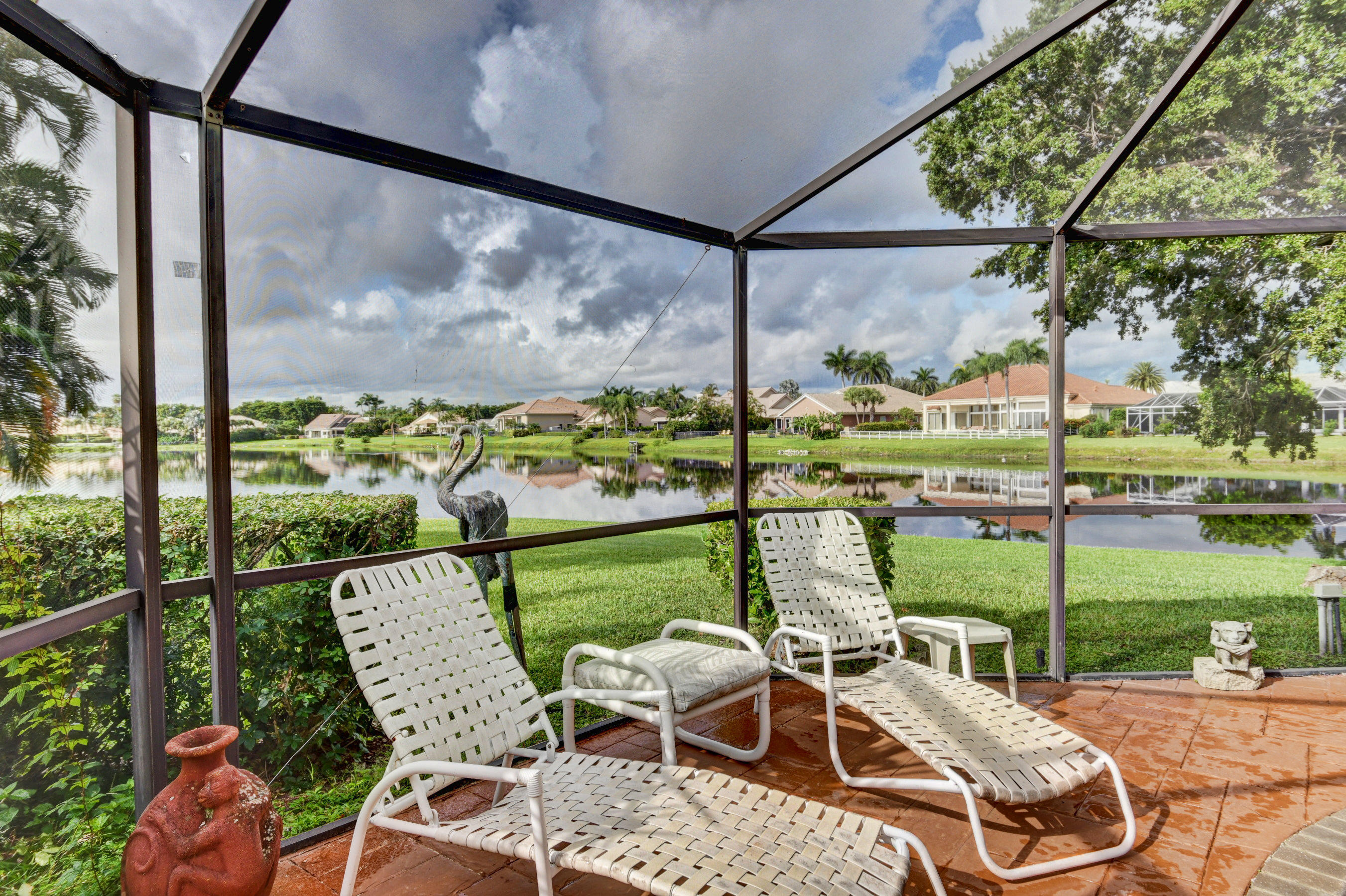17331 Springtree Lane Boca Raton, FL 33487 - Photo 38 of 60 a view of a chairs and table in the patio