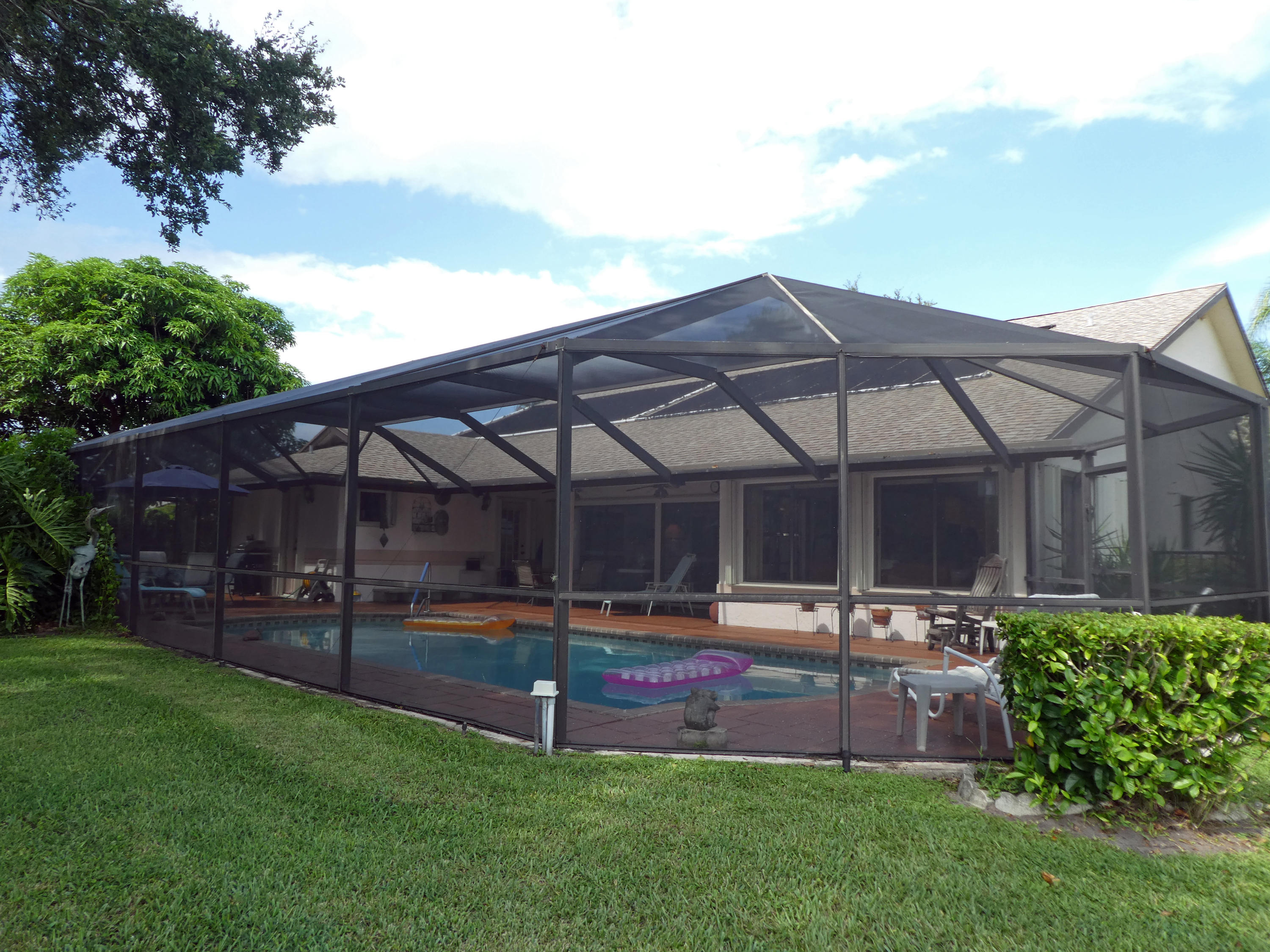 17331 Springtree Lane Boca Raton, FL 33487 - Photo 40 of 60 a backyard of a house with table and chairs