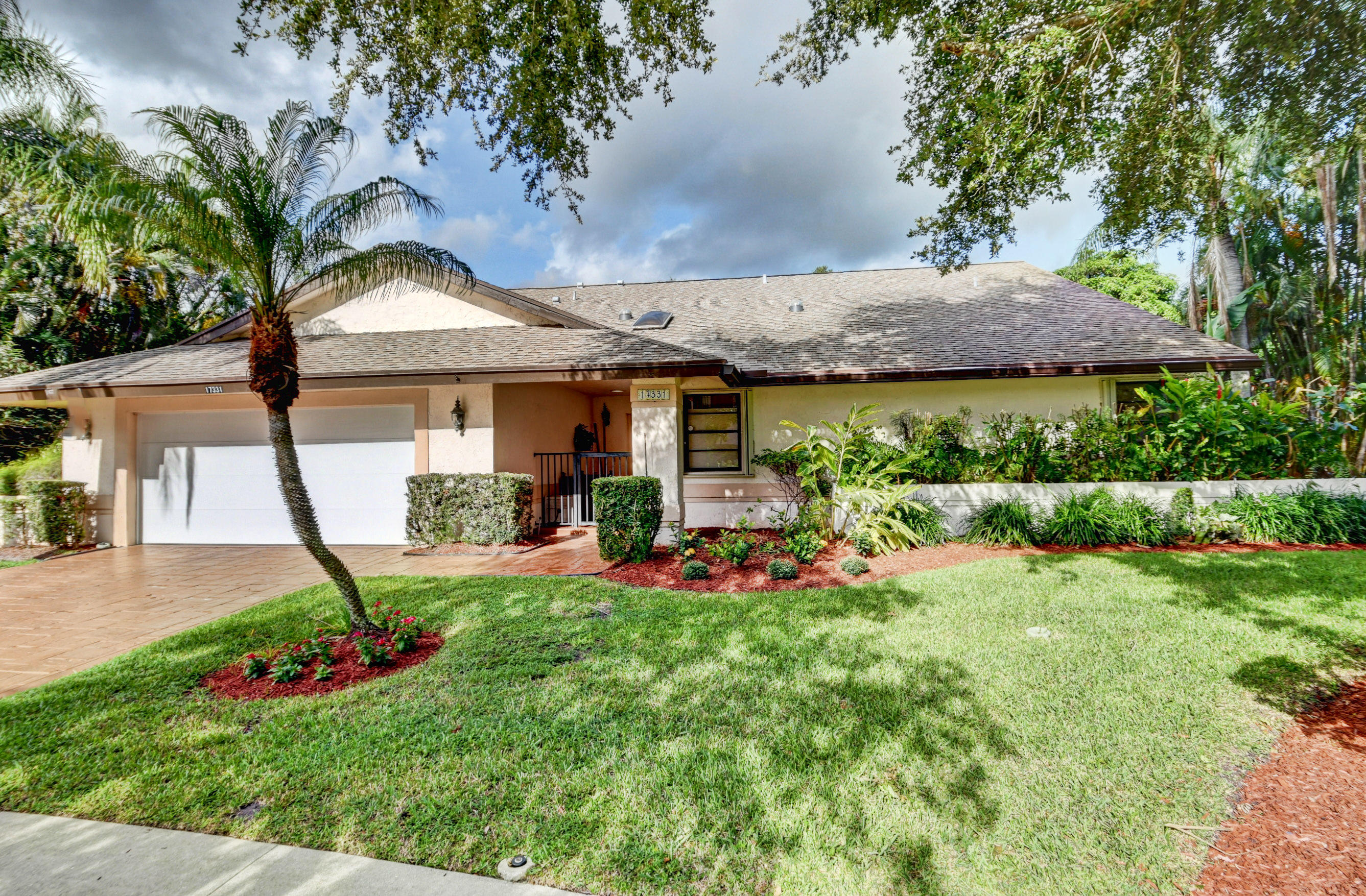 17331 Springtree Lane Boca Raton, FL 33487 - Photo 60 of 60 a front view of a house with a garden and plants