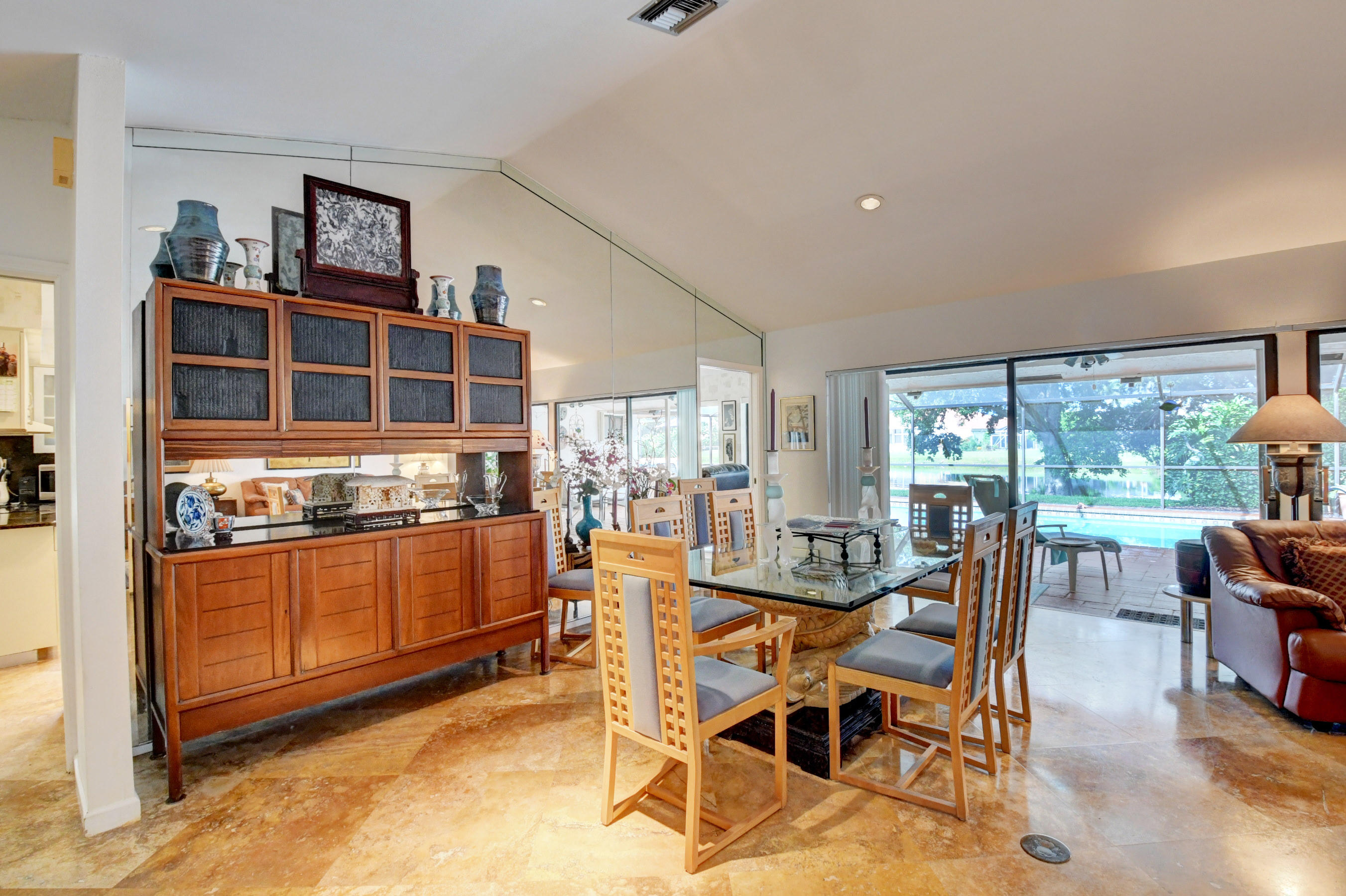 17331 Springtree Lane Boca Raton, FL 33487 - Photo 6 of 60 a dining room with stainless steel appliances furniture a large window and a kitchen view