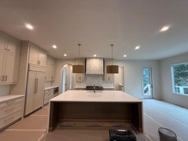a kitchen with a sink stainless steel appliances and cabinets