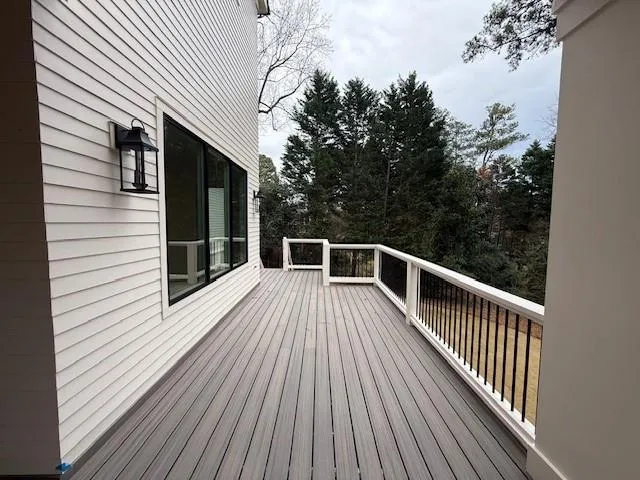 a view of balcony with wooden floor and fence