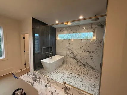 a bathroom with a bathtub and a shower