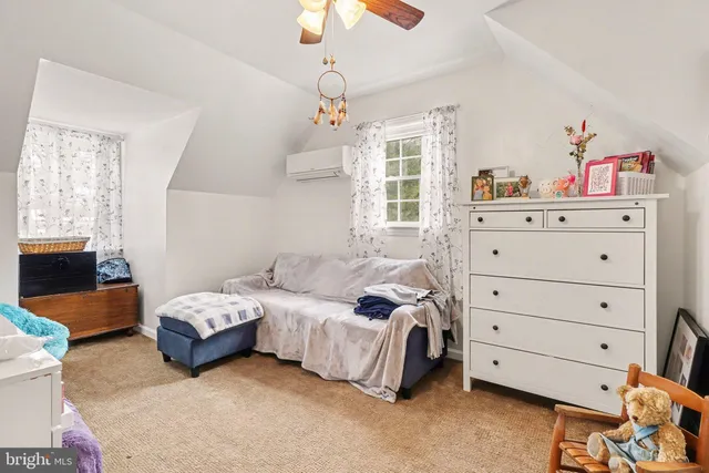 a bedroom with a bed and a chandelier fan