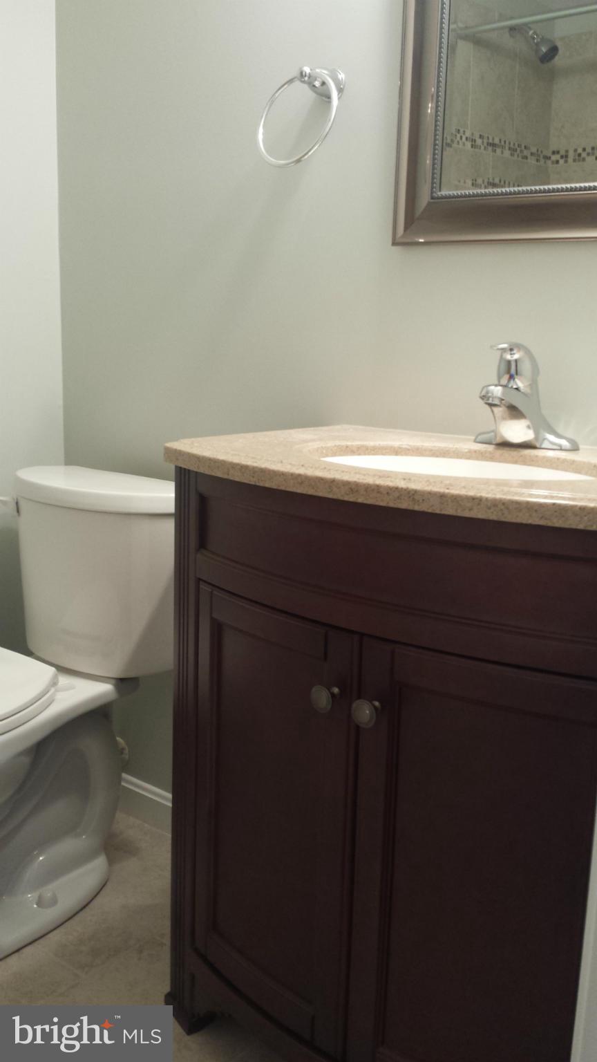8211 Riverside Road Alexandria, VA 22308 - Photo 22 of 27 a bathroom with a sink a toilet and vanity