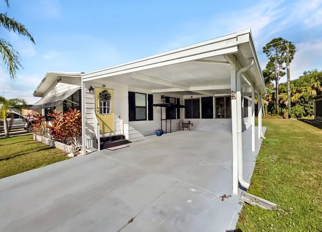 a view of a patio with table and chairs
