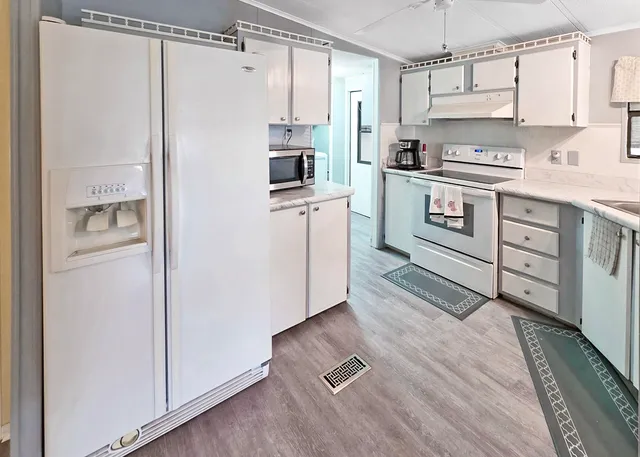 a kitchen with a refrigerator a stove a washer and dryer