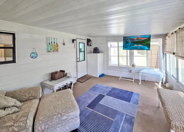 a bedroom with furniture and a large window