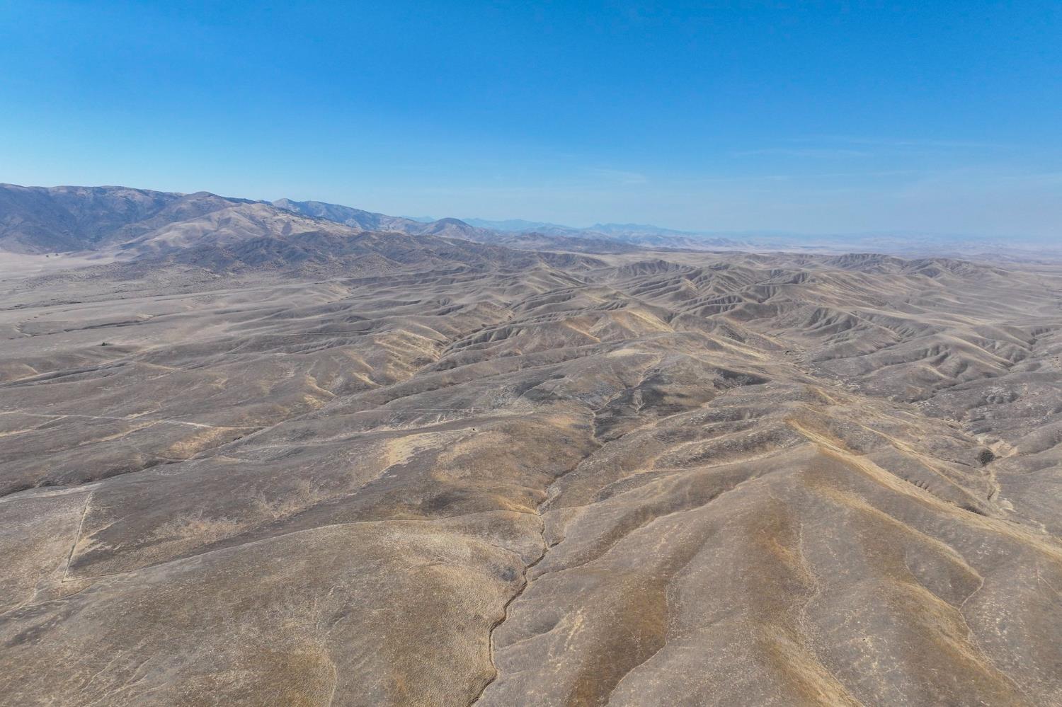 0 County Road 8335 Firebaugh, CA 93622 - Photo 2 of 6 a view of a dry yard with mountains in the background